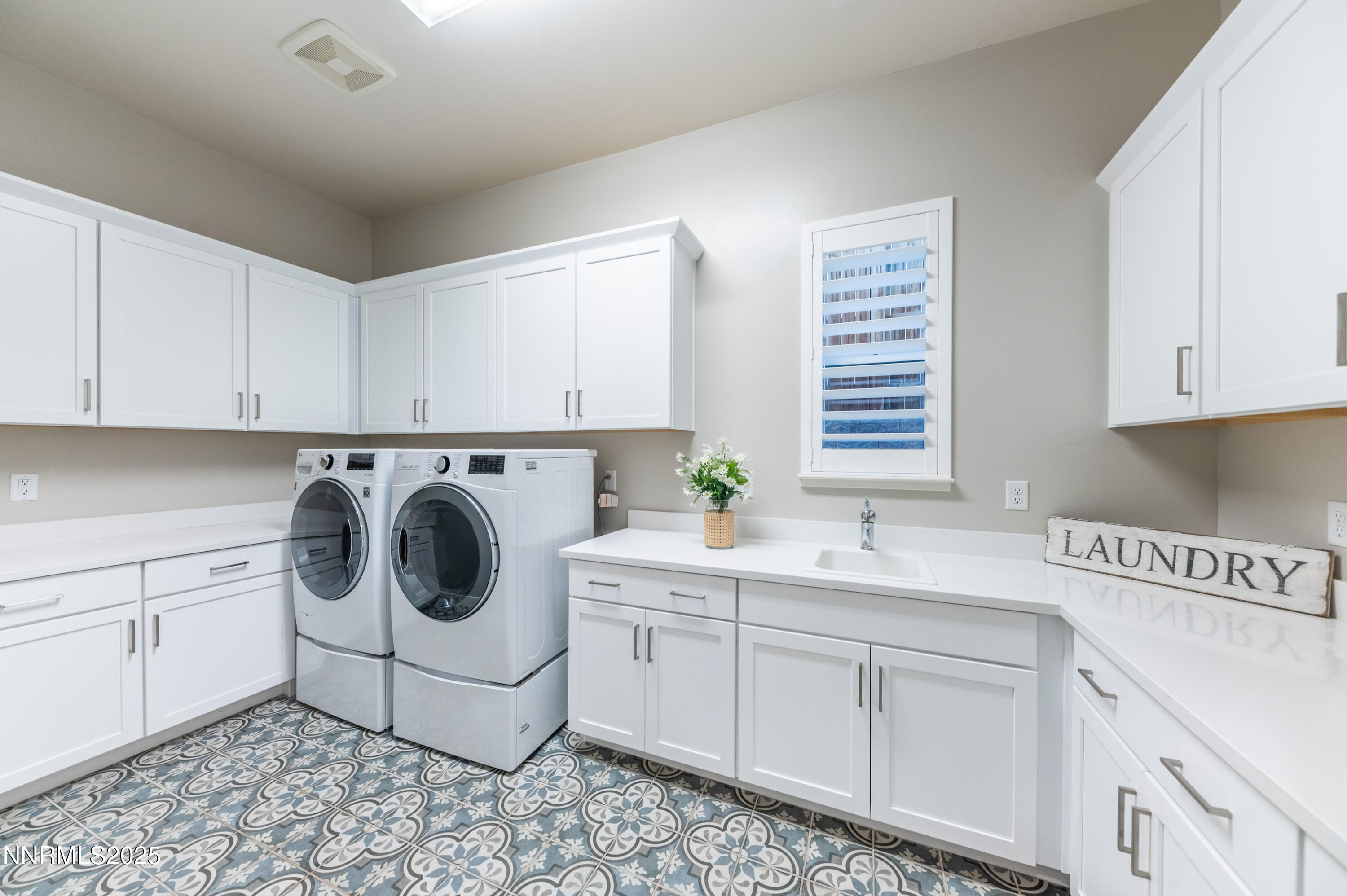 3034 Copper Stone Drive Reno, NV 89521 - Photo 16 of 24 a utility room with cabinets washer and dryer