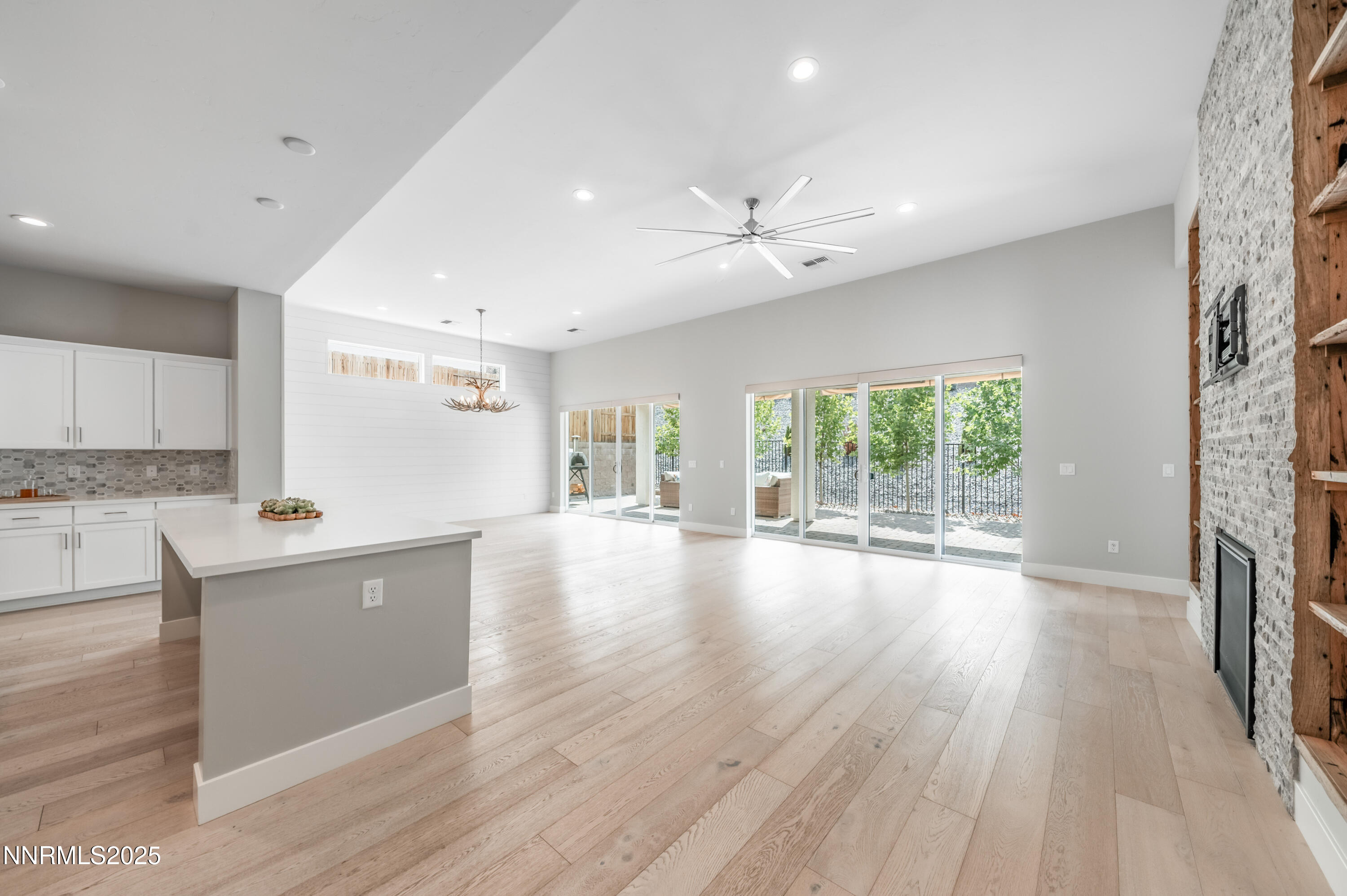 3034 Copper Stone Drive Reno, NV 89521 - Photo 8 of 24 a view of an empty room with wooden floor and a window
