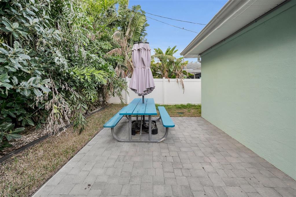 15812 3rd Street East Redington Beach, FL 33708 - Photo 13 of 19 a vase of flowers sitting on a floor