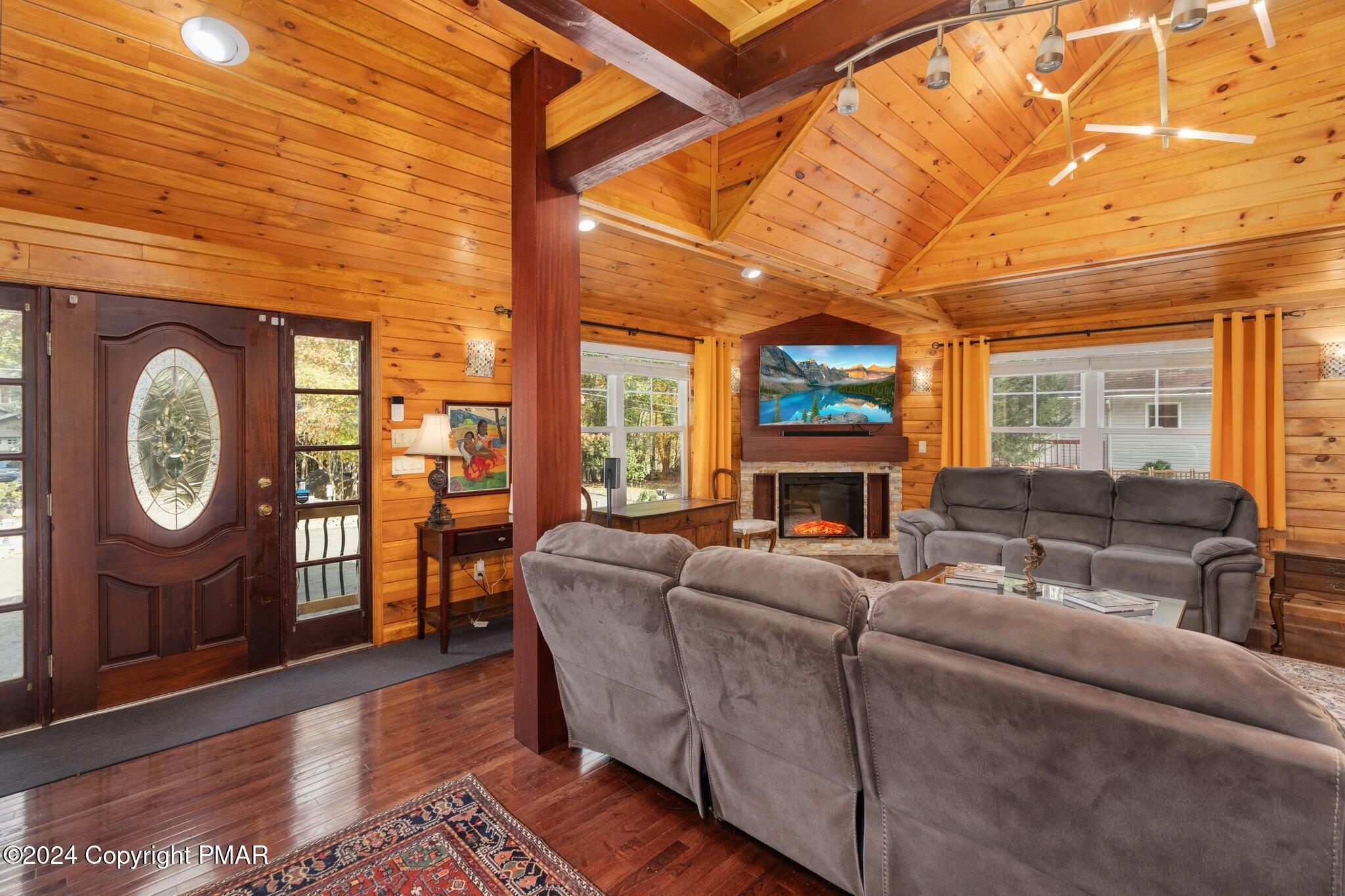 271 4 Seasons Drive Drums, PA 18222 - Photo 17 of 74 a living room with furniture a fireplace a clock and a large window