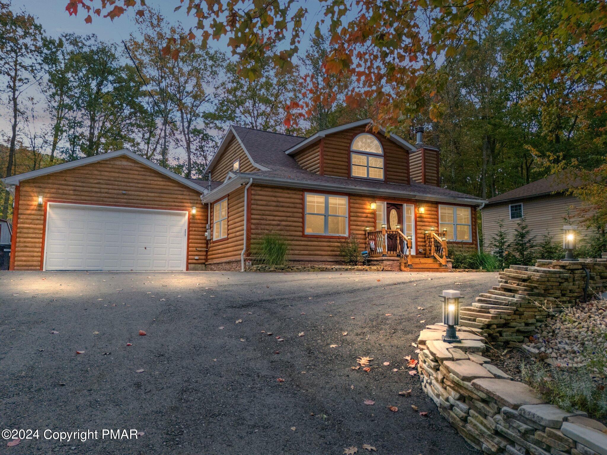 271 4 Seasons Drive Drums, PA 18222 - Photo 2 of 74 a front view of a house with a yard and garage
