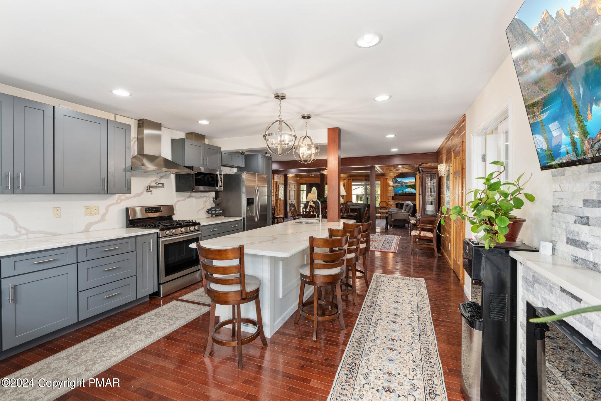 271 4 Seasons Drive Drums, PA 18222 - Photo 32 of 74 a kitchen with stainless steel appliances kitchen island granite countertop a table chairs sink and cabinets