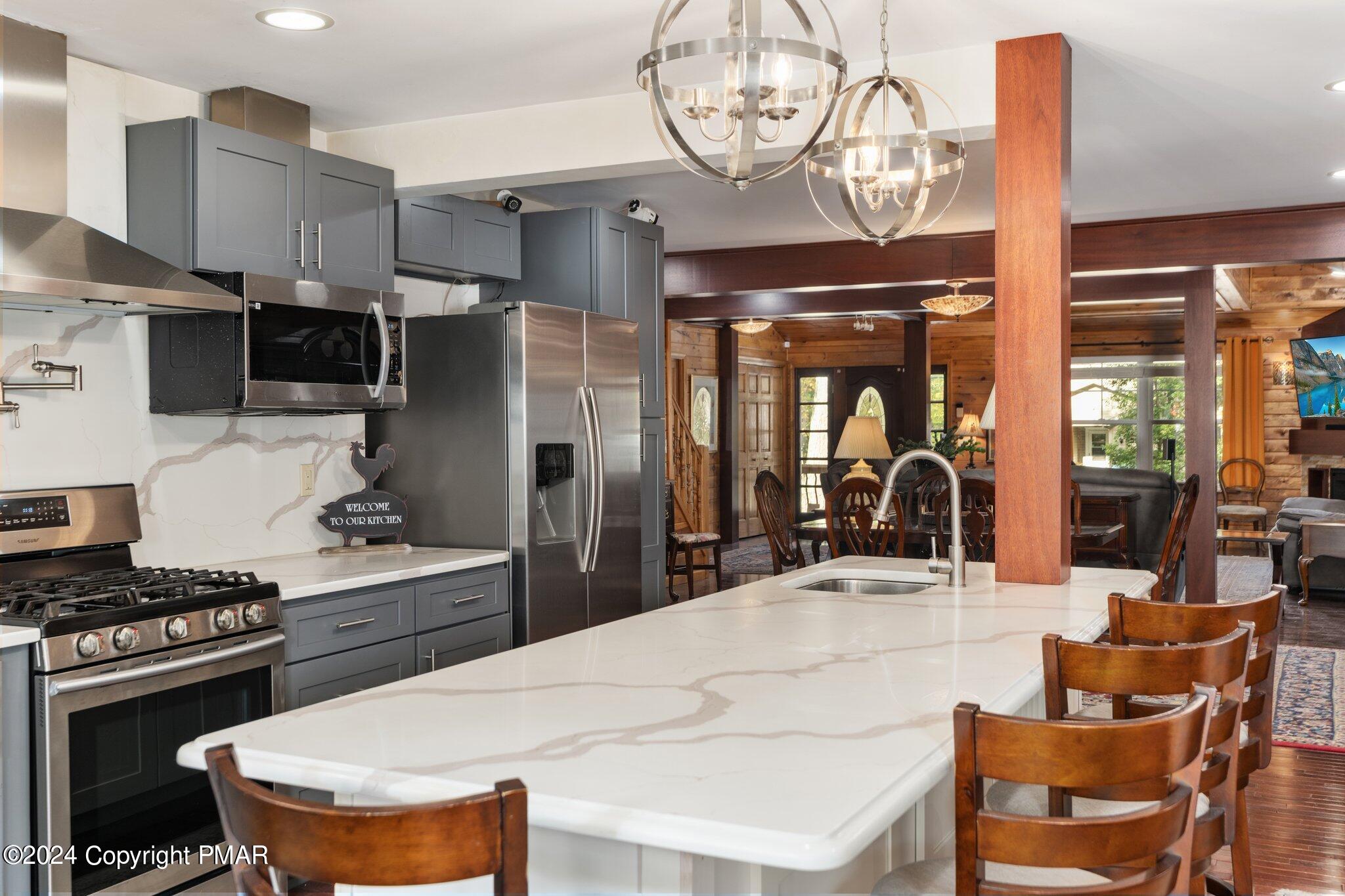 271 4 Seasons Drive Drums, PA 18222 - Photo 33 of 74 a kitchen with stainless steel appliances a table chairs and a refrigerator
