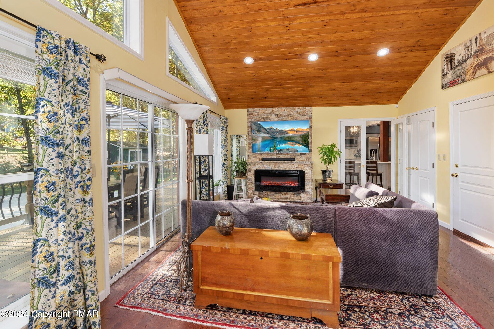 271 4 Seasons Drive Drums, PA 18222 - Photo 40 of 74 a living room with furniture a fireplace and a chandelier