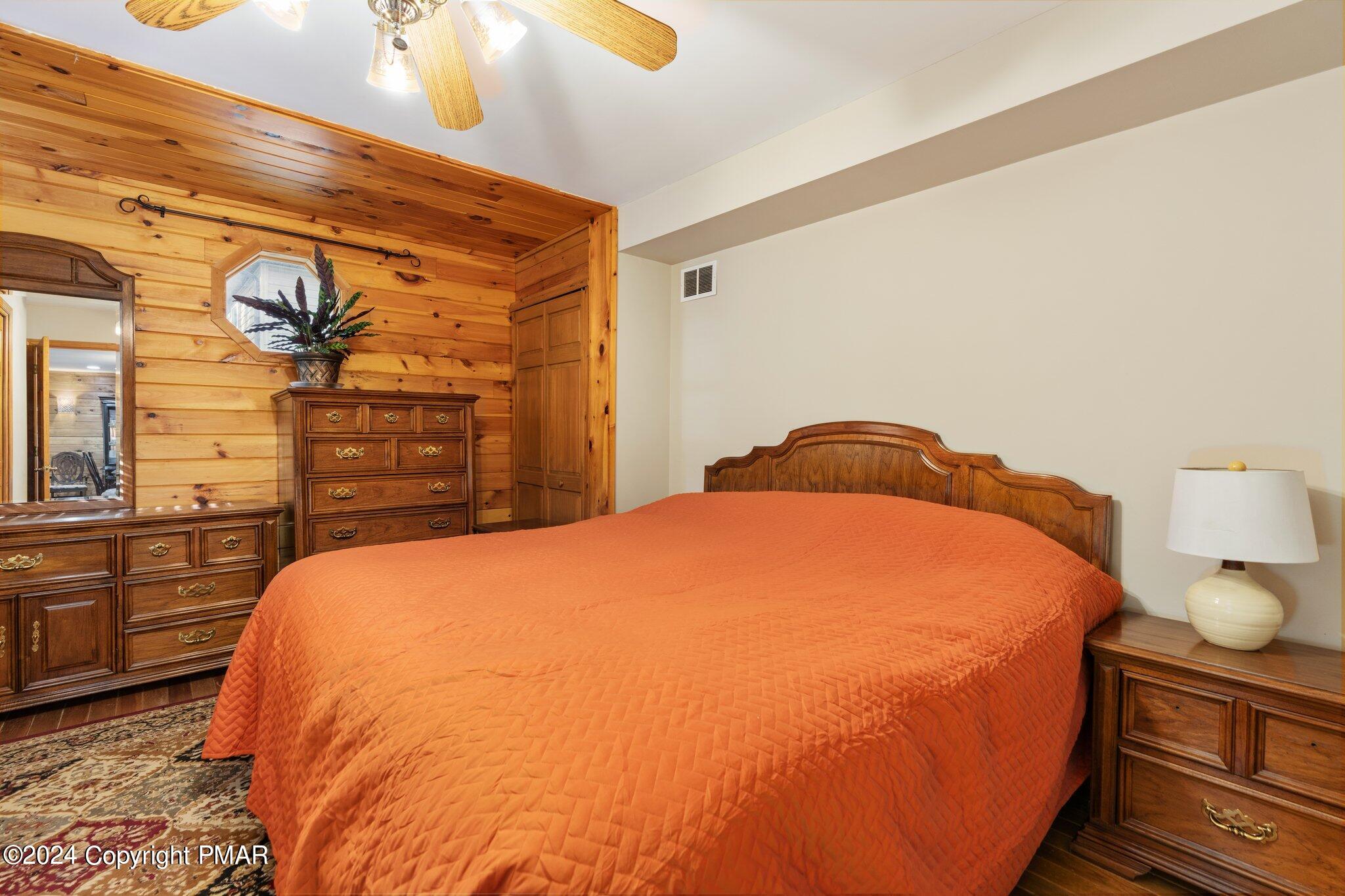 271 4 Seasons Drive Drums, PA 18222 - Photo 49 of 74 a bedroom with a bed and dresser with mirror