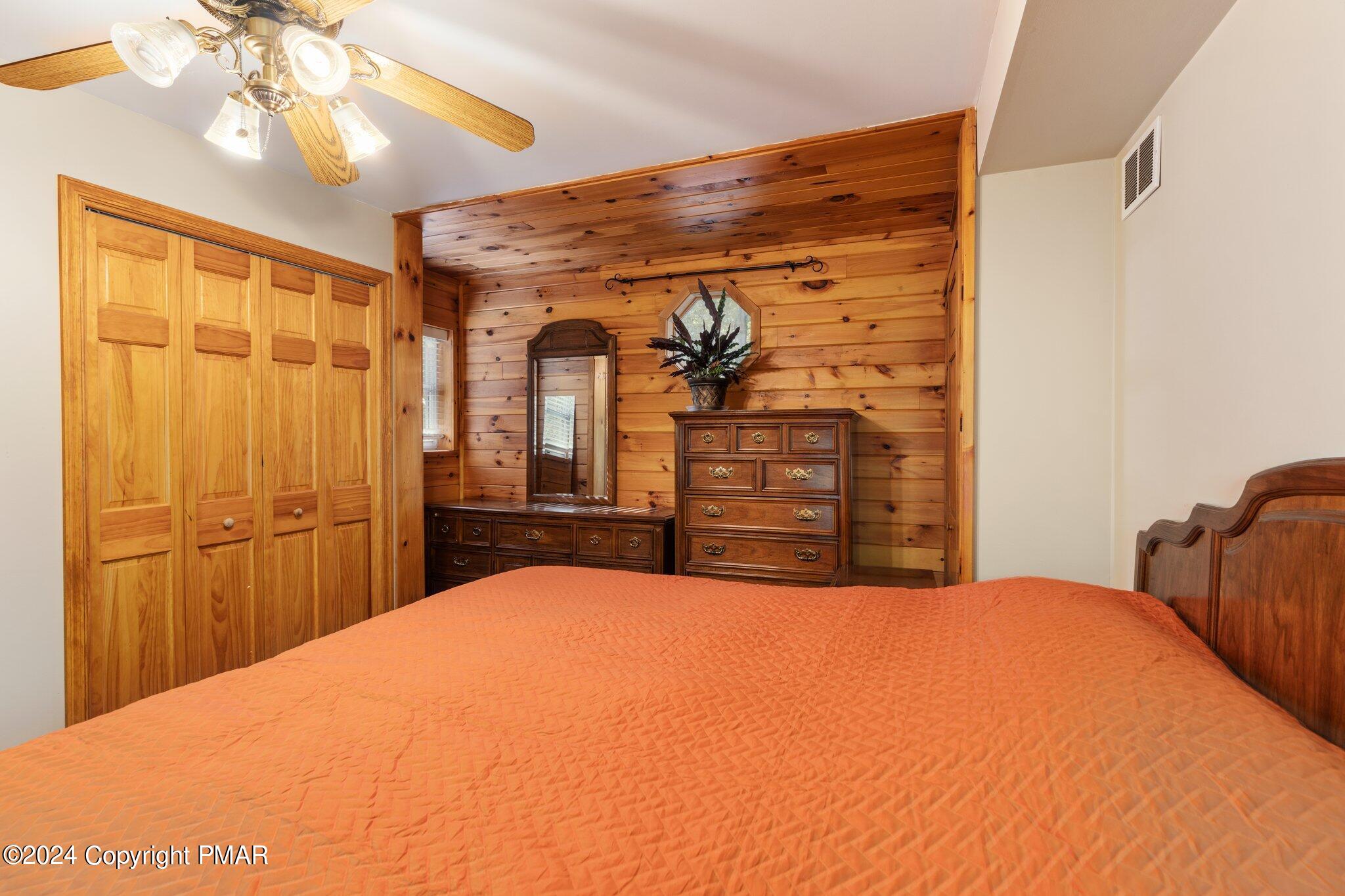 271 4 Seasons Drive Drums, PA 18222 - Photo 50 of 74 a bedroom with a large bed and a chandelier