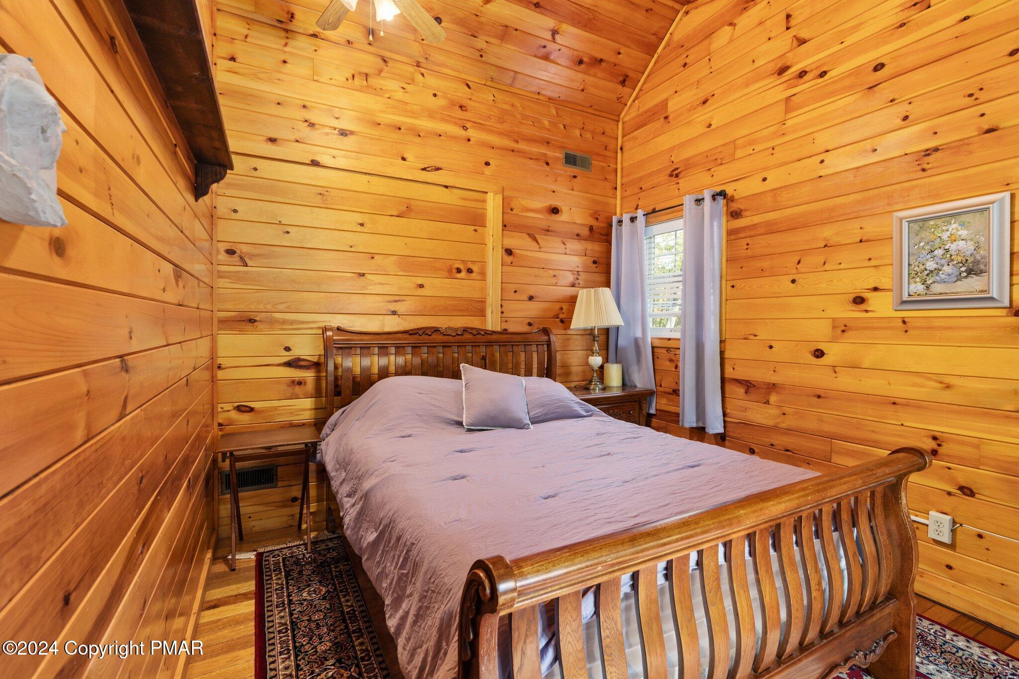 271 4 Seasons Drive Drums, PA 18222 - Photo 56 of 74 a bedroom with a bed and wooden floor