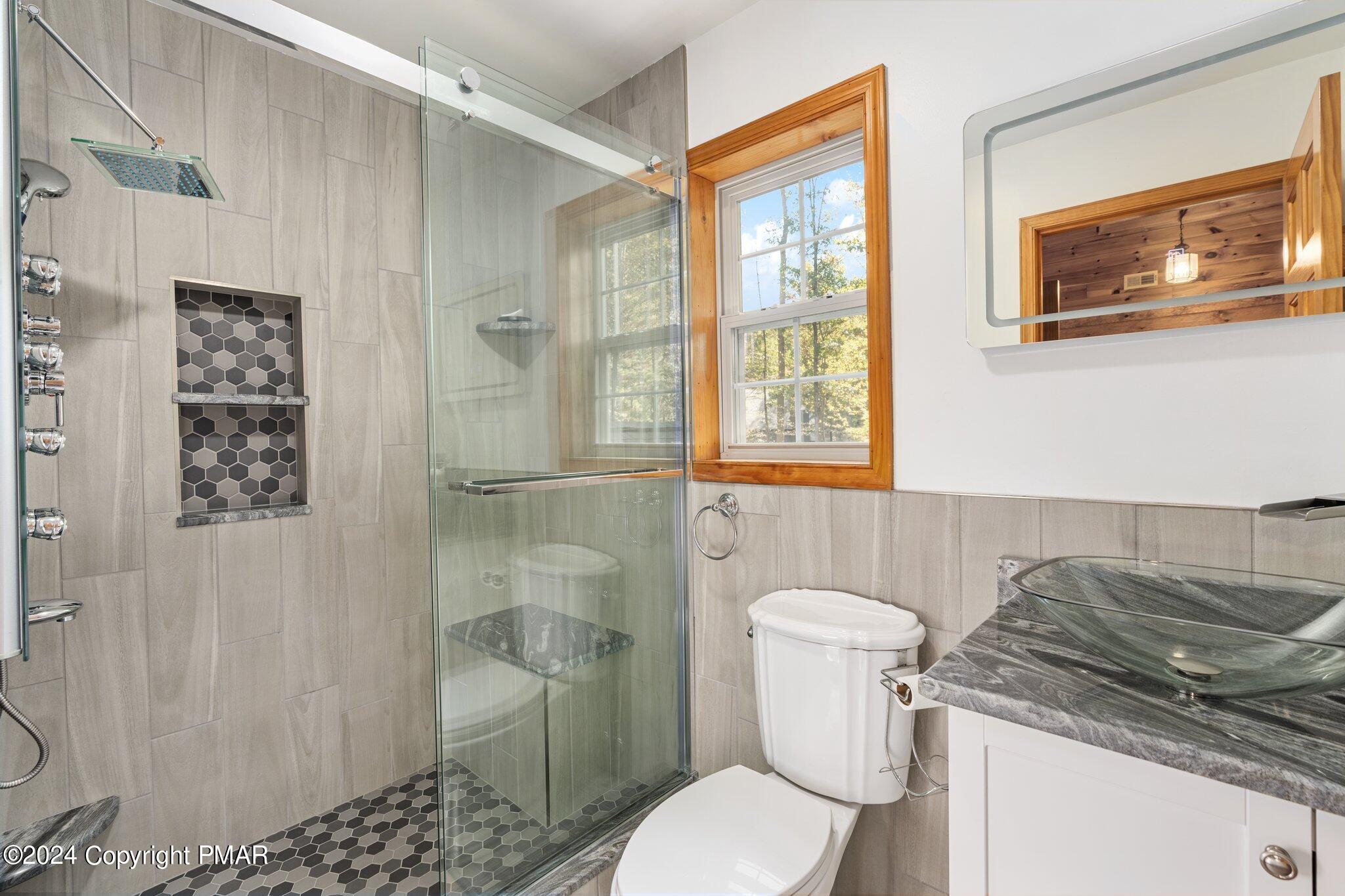 271 4 Seasons Drive Drums, PA 18222 - Photo 58 of 74 a bathroom with a granite countertop toilet sink and shower
