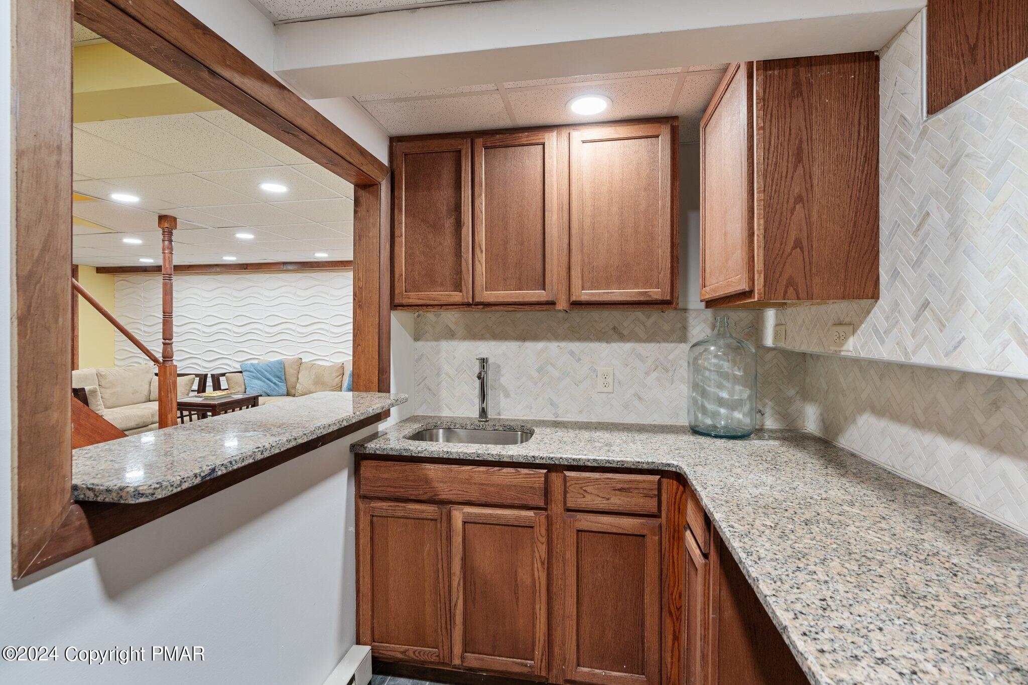 271 4 Seasons Drive Drums, PA 18222 - Photo 65 of 74 a kitchen with stainless steel appliances granite countertop a sink a stove and a wooden cabinets