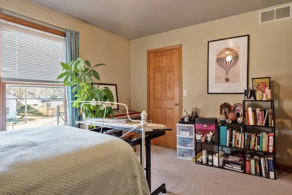 a bedroom with furniture and a window