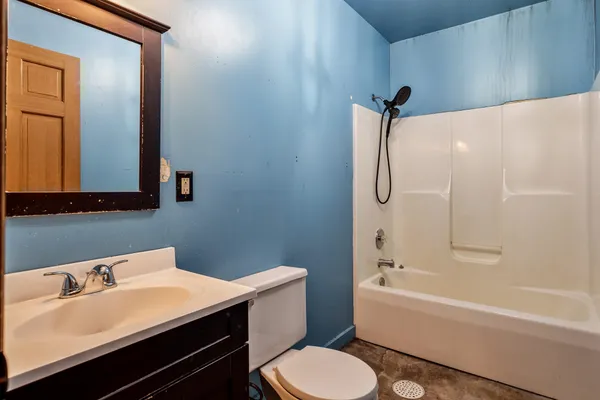 a bathroom with a sink toilet vanity and shower
