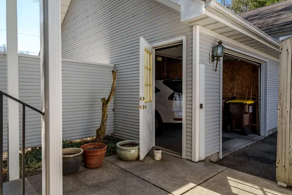 a view of a patio with table and chairs and potted plants