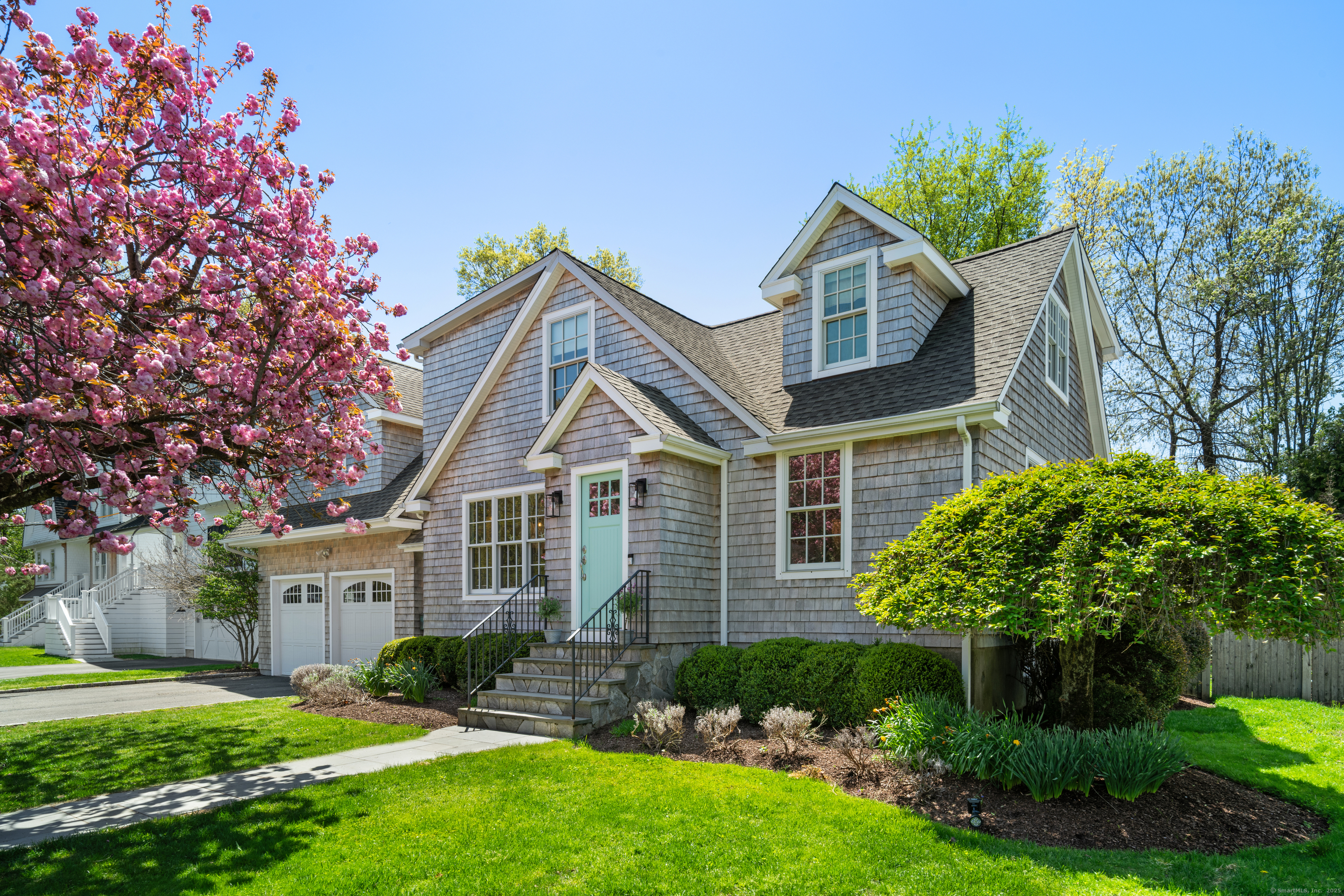 164 Oldfield Drive Fairfield, CT 06824 - Photo 1 of 1 a front view of a house with a garden and plants