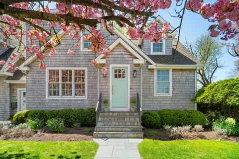 a front view of a house with garden