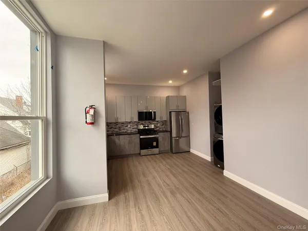 a kitchen with stainless steel appliances a refrigerator and a stove top oven