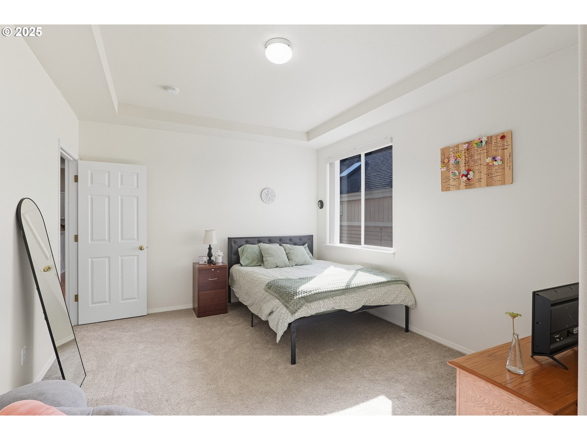 27129 Southwest Aden Avenue Wilsonville, OR 97070 - Photo 16 of 31 a bedroom with a bed and a flat screen tv
