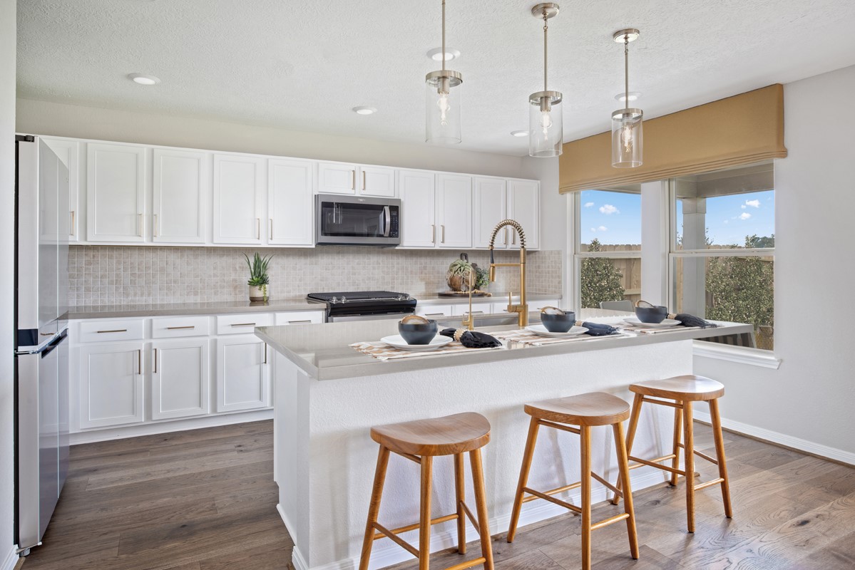18303 Walnut Canopy Way Tomball, TX 77377 - Photo 3 of 8 a kitchen with stainless steel appliances granite countertop a sink a stove a refrigerator cabinets and chairs