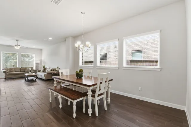 a dining room with furniture and wooden floor