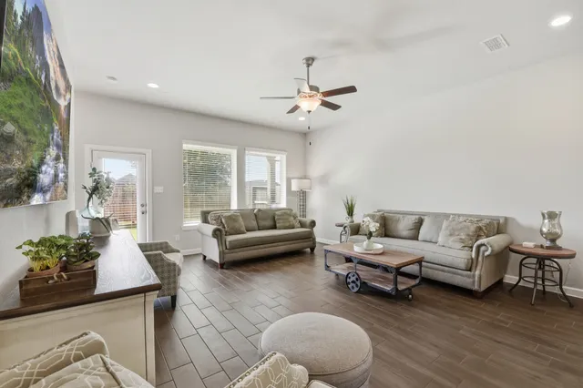 a living room with furniture and a chandelier