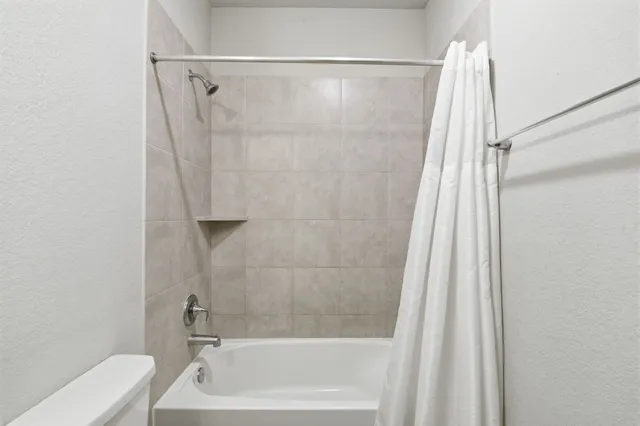 a bathroom with a shower and a tub