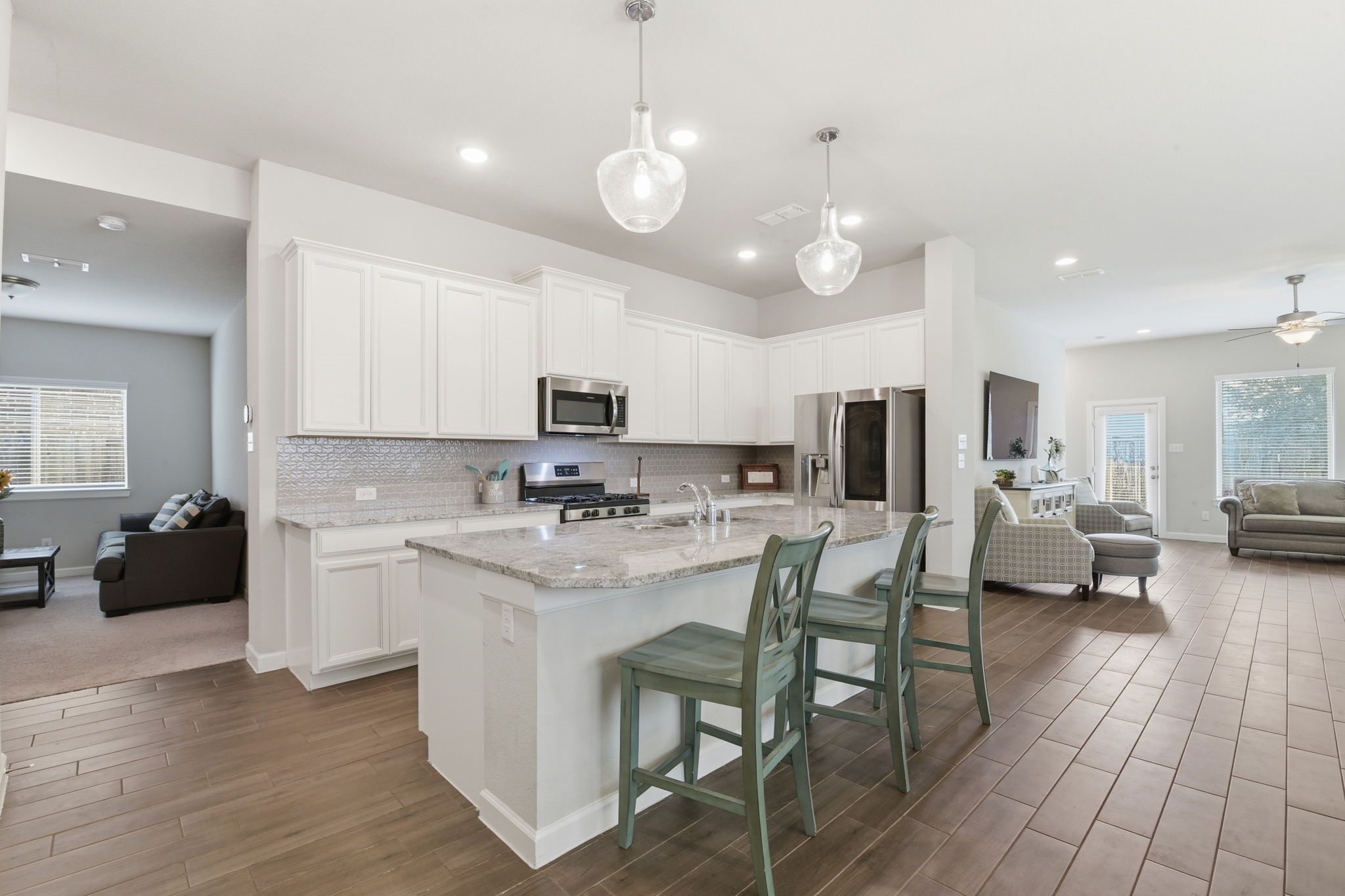 3410 Shockley Lane Rosharon, TX 77583 - Photo 8 of 29 a kitchen with a dining table chairs refrigerator and microwave