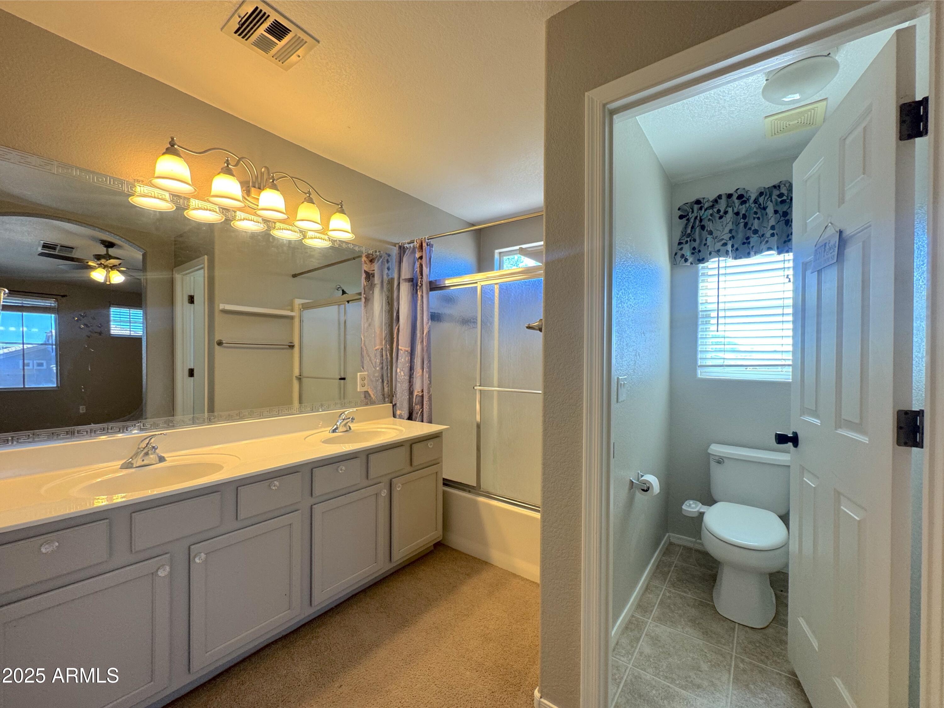 9331 East Lompoc Avenue Mesa, AZ 85209 - Photo 14 of 15 a spacious bathroom with a double vanity sink toilet mirror and bathtub