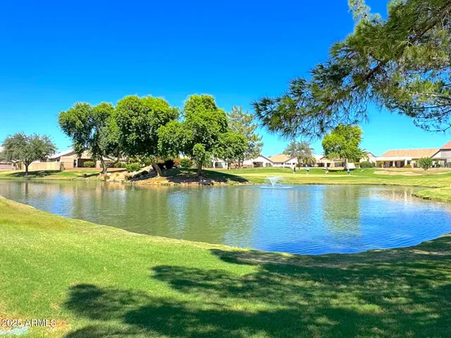 a view of a lake with houses in the back