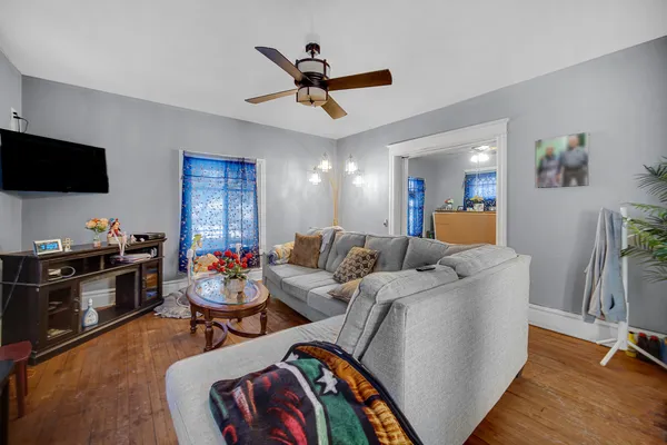 a living room with furniture kitchen view and a flat screen tv