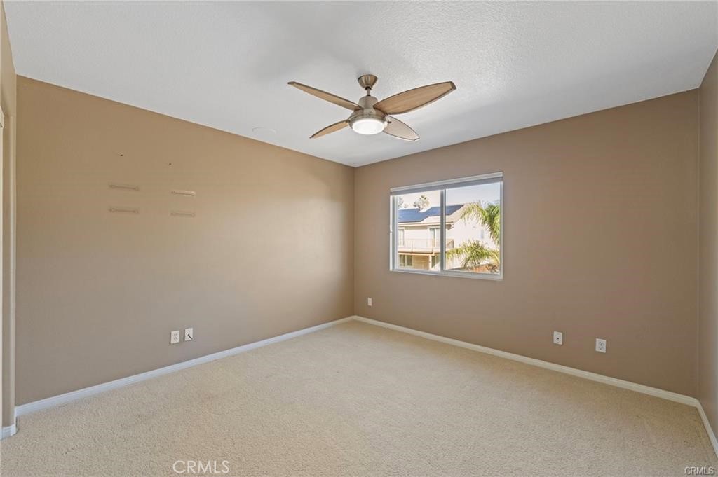 8634 Hunt Canyon Road Corona, CA 92883 - Photo 21 of 31 an empty room with a window and a fan