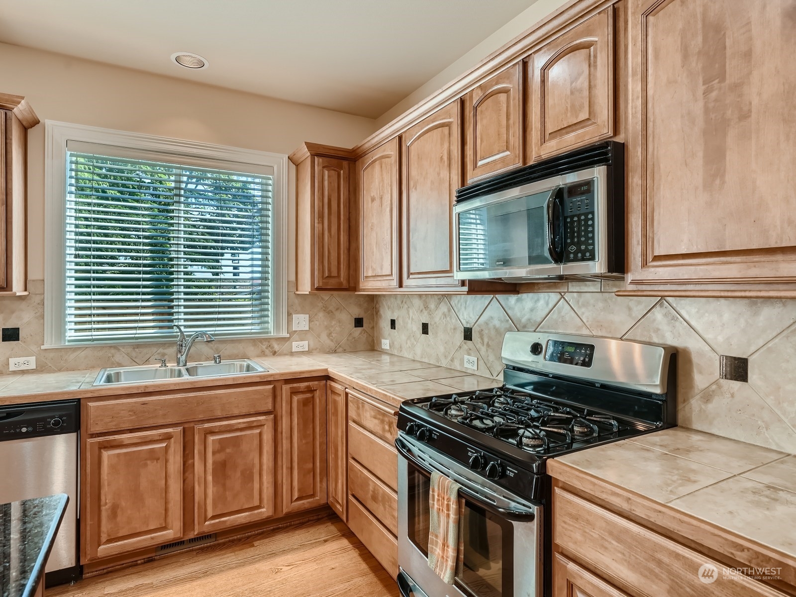 5215 Northeast 3rd Place Renton, WA 98059 - Photo 8 of 23 a kitchen with stainless steel appliances a sink stove and cabinets
