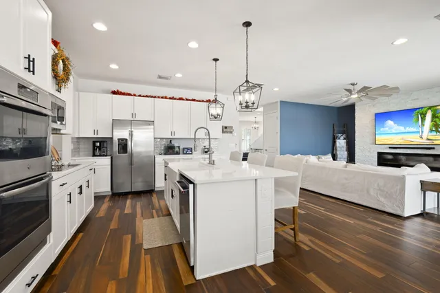 a kitchen that has a lot of cabinets and refrigerator