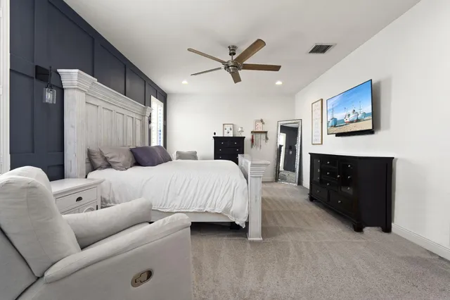 a bed room with a bed and a television