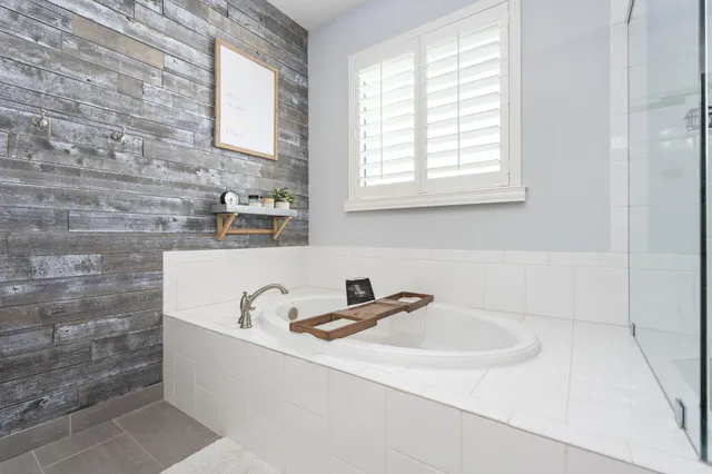 a bathroom with a sink a window and a shower
