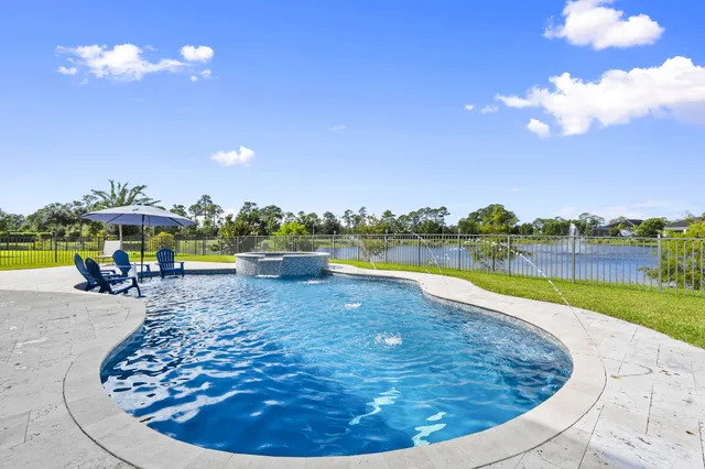 a view of a swimming pool with an outdoor seating