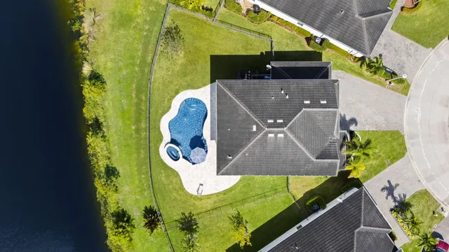 an aerial view of a house with a swimming pool yard and outdoor seating