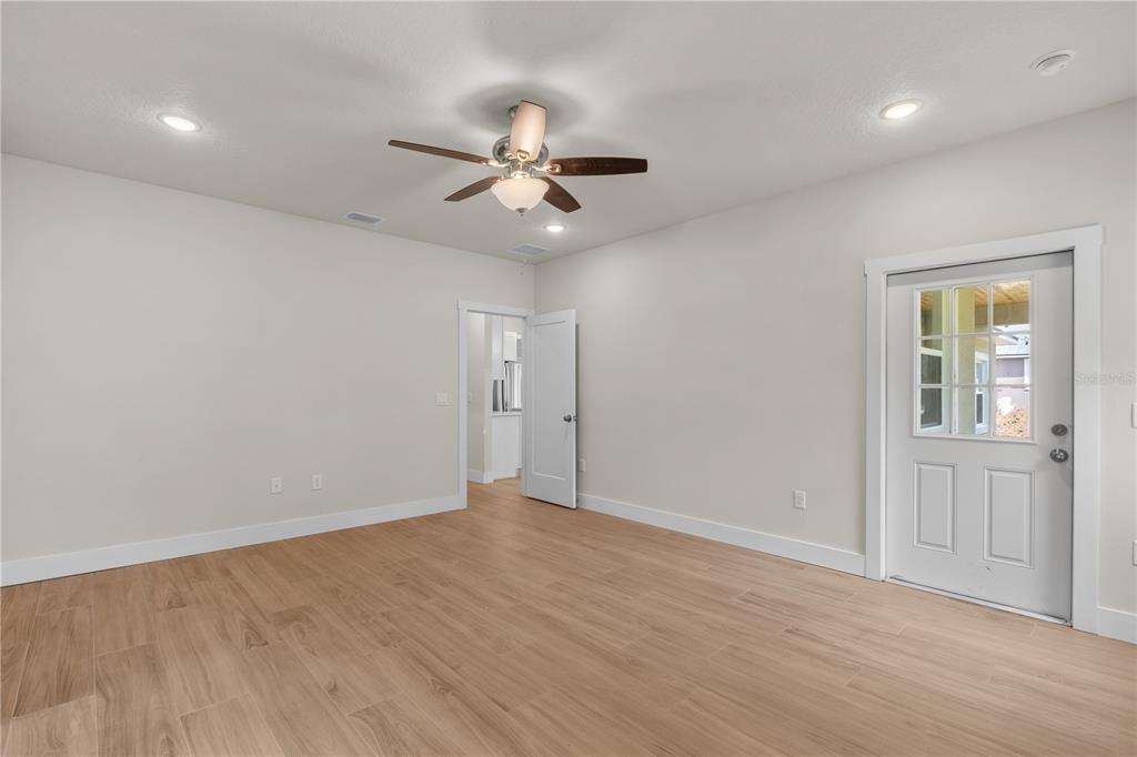 2066 Northwest 79th Loop Ocala, FL 34475 - Photo 11 of 15 wooden floor in an empty room with a window