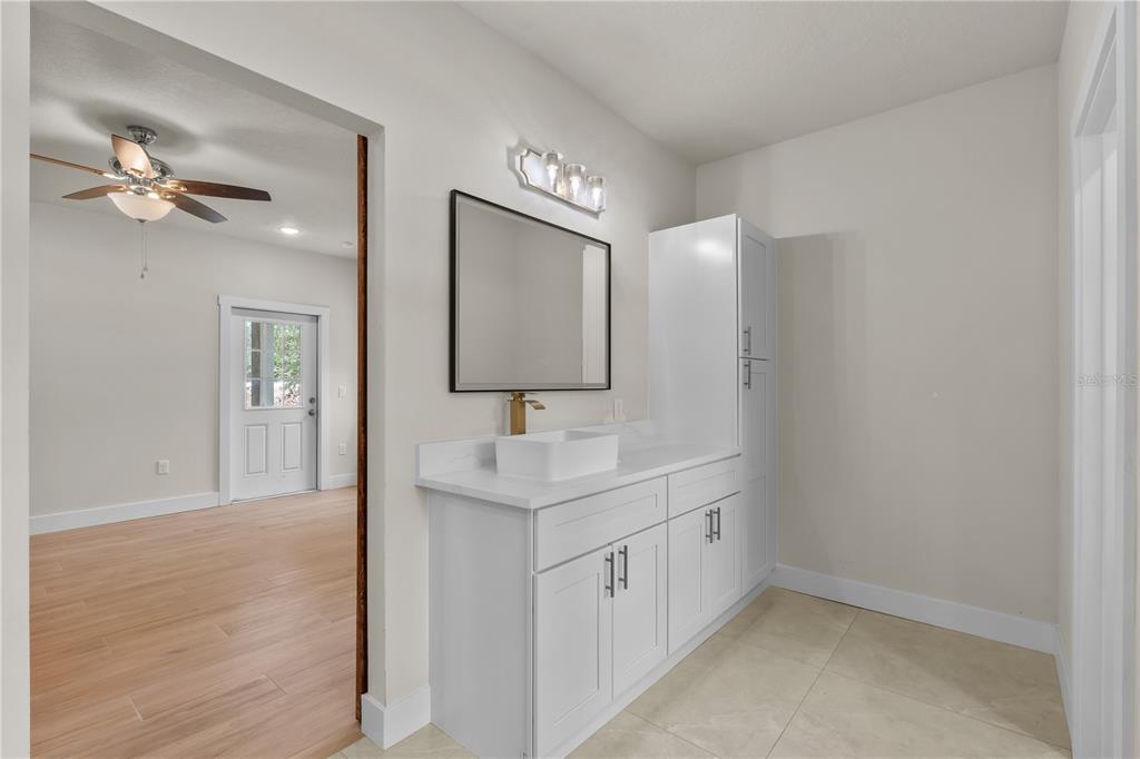 2066 Northwest 79th Loop Ocala, FL 34475 - Photo 14 of 15 a bathroom with a sink a light fixture and a mirror