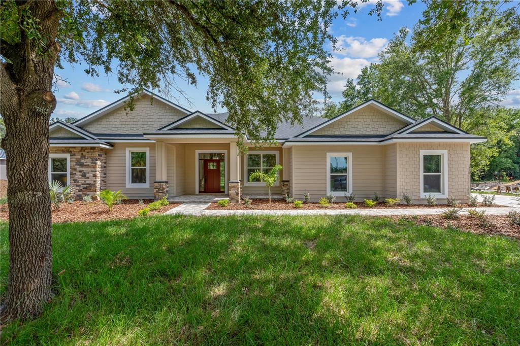 2066 Northwest 79th Loop Ocala, FL 34475 - Photo 2 of 15 a front view of a house with yard patio and green space