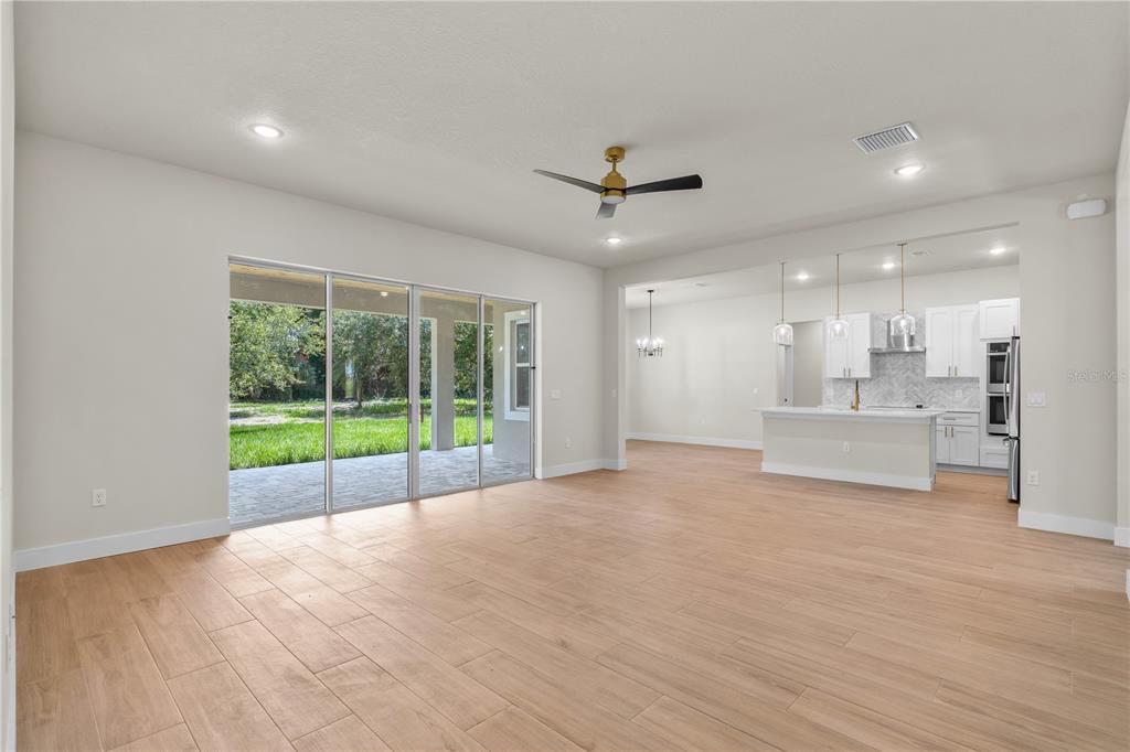 2066 Northwest 79th Loop Ocala, FL 34475 - Photo 3 of 15 a view of an empty room with a window and wooden floor