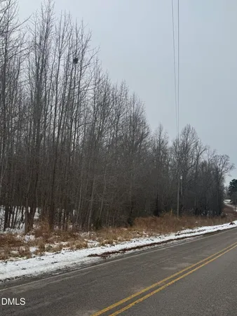 a view of a house with a yard next to a road