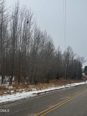 a view of a house with a yard next to a road