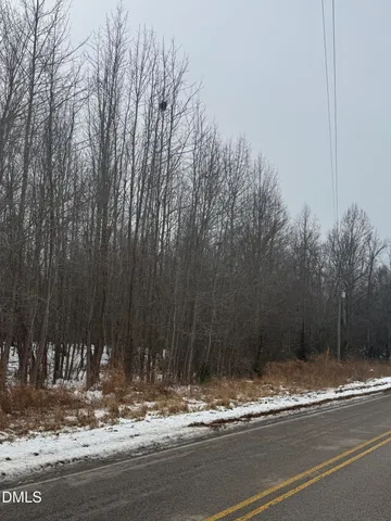 a view of a house with trees in the background