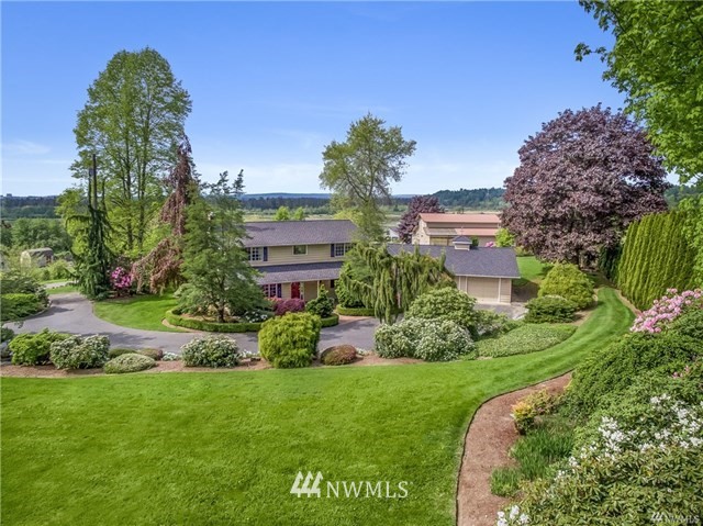 7621 Skipley Road Snohomish, WA 98290 - Photo 3 of 25 a view of a garden with a building in the background