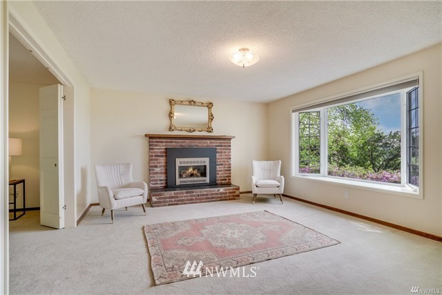 7621 Skipley Road Snohomish, WA 98290 - Photo 9 of 25 a living room with furniture and a fireplace
