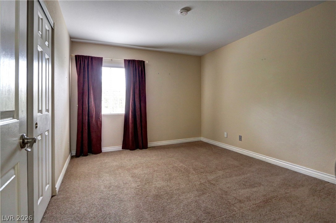 2108 Crestpoint Way Las Vegas, NV 89134 - Photo 18 of 27 A well-proportioned room featuring a window with draping, offering a tranquil retreat.