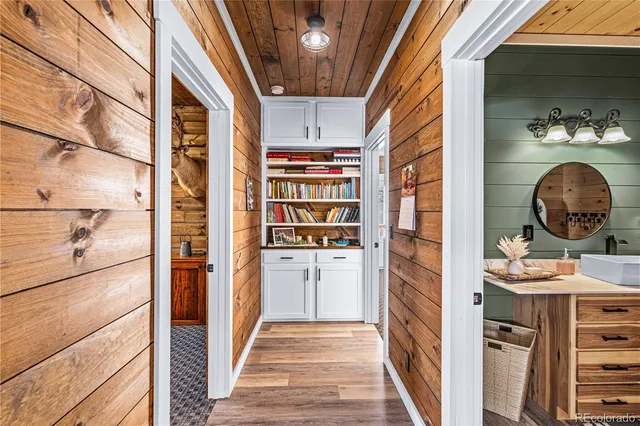 a view of a hallway and a dining room with wooden floor
