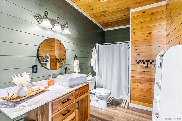 a bathroom with a sink mirror toilet and shower