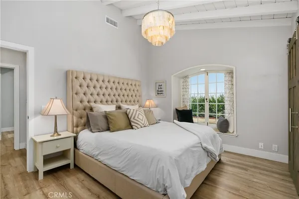 a bedroom with a bed and a window