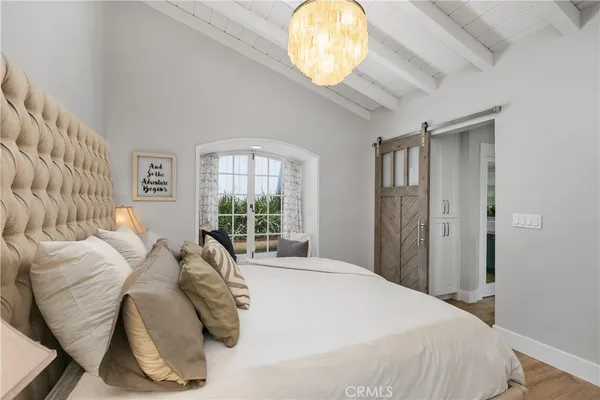 a bed sitting in a bedroom next to a window