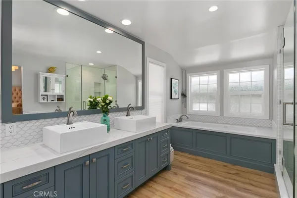 a bathroom with double vanity and a large mirror